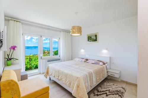 a bedroom with a bed and a large window at Apartmani Katica in Povile