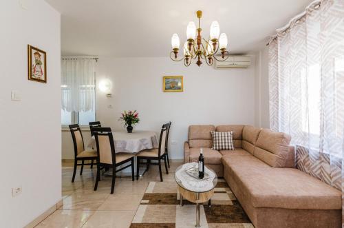 a living room with a couch and a table at Apartmani Katica in Povile