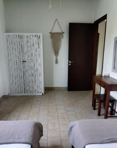 a room with a door and a table and a desk at Alcyon days in Agios Georgios