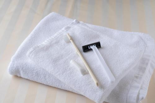 a white towel with two chopsticks on top of it at HOTEL CITY INN WAKAYAMA Wakayama-Ekimae in Wakayama