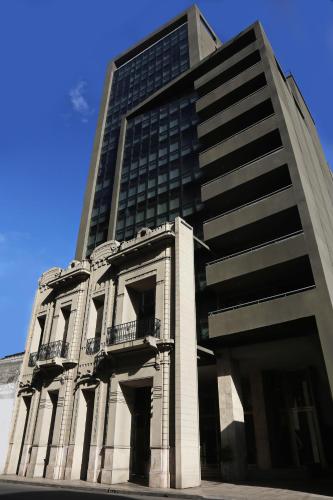 a tall building with a large building at The Point Casa Edificio Boutique in San Miguel de Tucumán