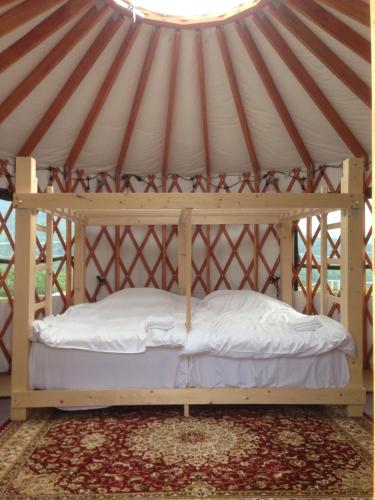 a bed in a yurt with a ceiling at The Yurts at Margo's Garden, Kiroro in Akaigawa