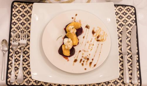 a plate of food with ice cream and sauce at Riad Chebbi in Merzouga
