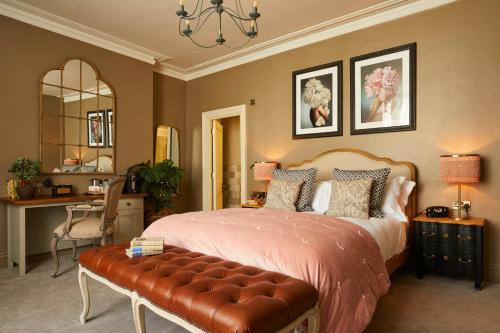 a bedroom with a large bed with a bench in it at Broad Street Townhouse in Bath