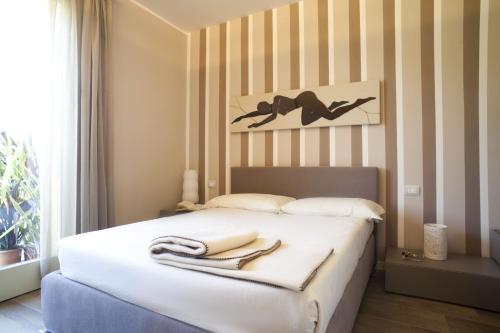 a bedroom with a bed with a towel on it at Residence Borgo Del Cigno in Spinone Al Lago