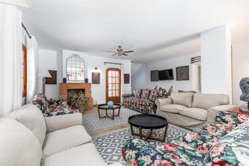 a living room with couches and a fireplace at La Colina in Puebla de Vallbona