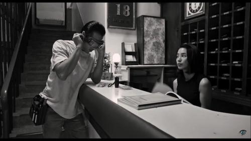 a man standing in front of a counter with a woman at Yongxing Inn in Chiayi City