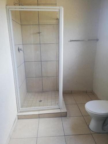 a bathroom with a shower and a toilet at BTV Guesthouse in Hazyview