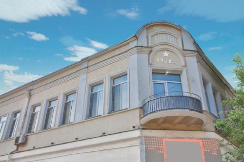 a building with a balcony on the side of it at Chveni Qalaqi in Kutaisi