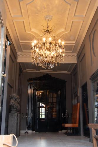 a chandelier hanging from a ceiling in a room at Zeeuws onder-onsje in Middelburg
