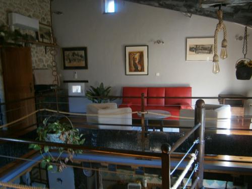 a living room with a couch and a table at Gite l'Etape in Vallon-Pont-dʼArc