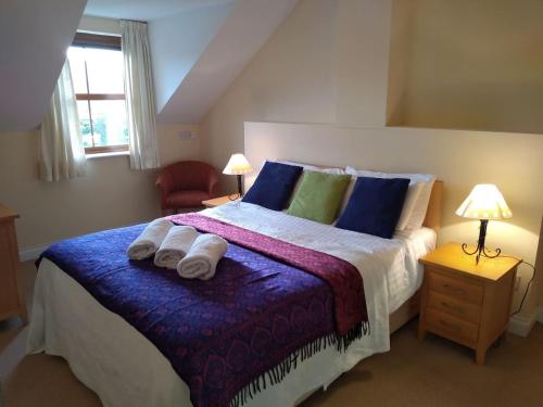 a bedroom with a large bed with towels on it at Tranquil sea view in Kenmare in Kenmare