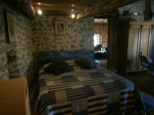 a bedroom with a bed with pillows on it at Gite l'Etape in Vallon-Pont-dʼArc