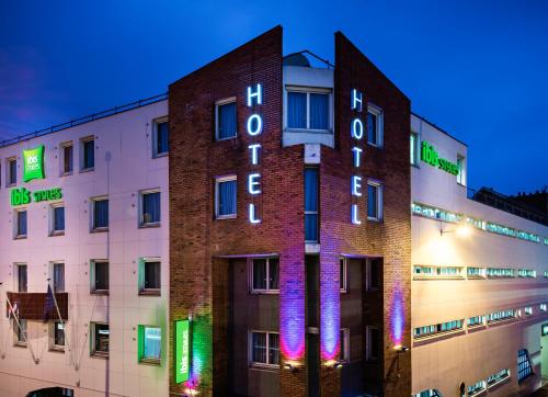 a building with a sign on the side of it at Ibis Styles Reims Centre in Reims