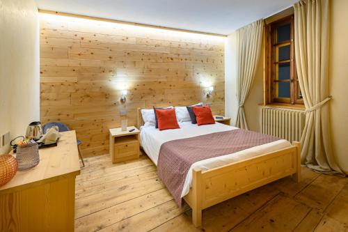 a bedroom with a bed and a wooden wall at B&B Antica Residenza Centro Storico in Tirano