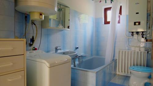a bathroom with a tub and a sink and a toilet at Charlie Vendégház,emelet 8 fős,100m2-es apartman in Siófok