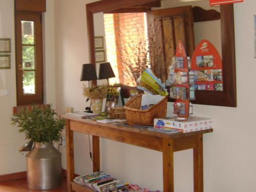 a dressing table in a room with a mirror at Apartamentos Dos Robles in Somo