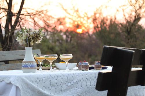 a table with a vase and some food on it at Donkerhoek Country Living in Avondzon