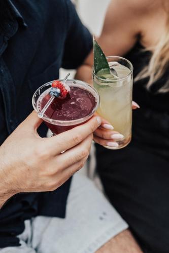 a person holding a drink in their hands at Hotel Place D'Armes in Montréal