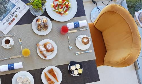 a table with plates of food and drinks on it at Hotel Villa Flora Relais in Caltanissetta