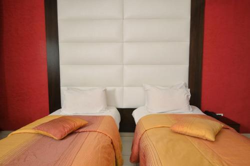 two beds sitting next to each other in a room at Hollywood Inn Boutique Hotel in Jounieh