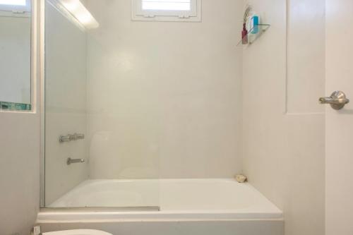 a white bathroom with a shower and a toilet at Soho Point Central in Buenos Aires
