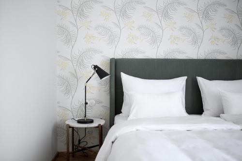 a bedroom with a bed and a lamp on a table at Villa Arnica in Lana