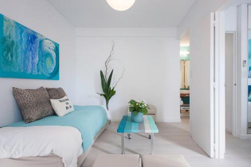 a living room with a blue couch and a table at Soho Point Central in Buenos Aires