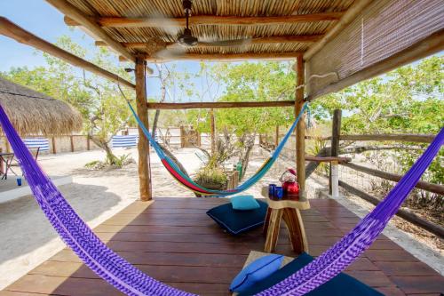 a hammock on the deck of a house at La Casa del Alux - Adults Only in Holbox Island