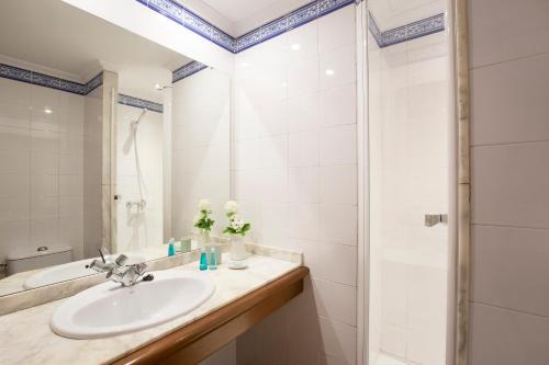 a bathroom with a sink and a shower at Villa Ca na Magdalena - La Goleta Hotel de Mar & Villas in Port de Pollensa