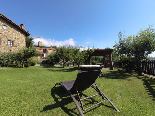 a chair sitting in the grass in a yard at CASA TERESA in Camaleño