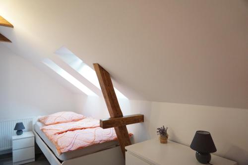 a bedroom with a bunk bed in a attic at Ferienhaus Lusatia am Töpfer in Kurort Oybin
