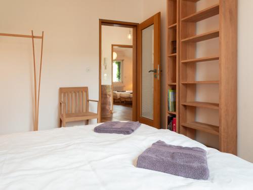 a bedroom with a bed with two towels on it at Gruppenhaus Darmstadt in Darmstadt
