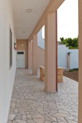an empty hallway of a house with a stone floor at B&B Mamma Carolina in Sanarica