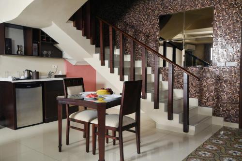 a kitchen with a table and a staircase at Hollywood Inn Boutique Hotel in Jounieh
