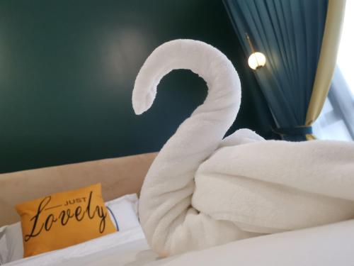 a white towel sitting on top of a bed at Legoland D'PRISTINE Apartment By TGP in Nusajaya