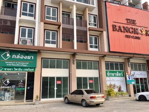 a car parked in front of a building at Hostbox Bangkok in Bangkok