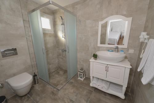 a bathroom with a shower and a sink and a toilet at Alesya Otel in Izmir