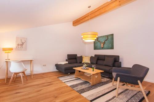 a living room with a couch and a table at Fewo Schönes Ammertal in Oberammergau