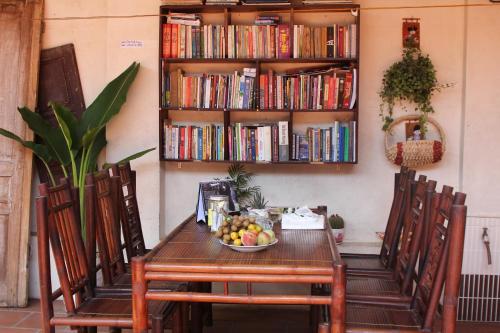 a table with two chairs and a bowl of fruit at Chicken's house- Đường Lâm Homestay in Hanoi