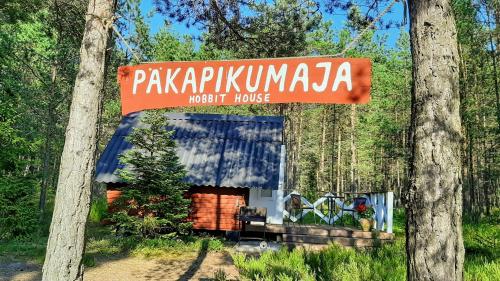 a sign for a patch house in the woods at Nõva Madise Guesthouse in Rannaküla