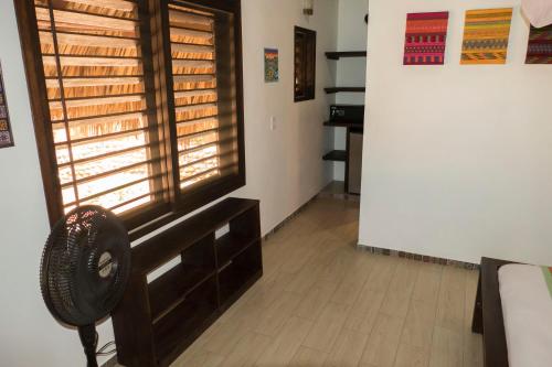 a room with a fan and a window in a room at Cabañas Amaia in Mazunte