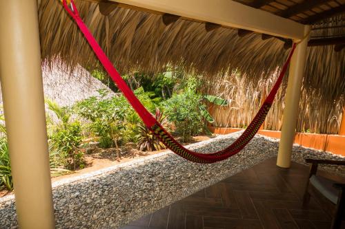 a red rope swing hanging from a porch at Cabañas Amaia in Mazunte