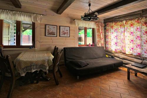 a living room with a couch and a table at Mazury-dom in Świętajno