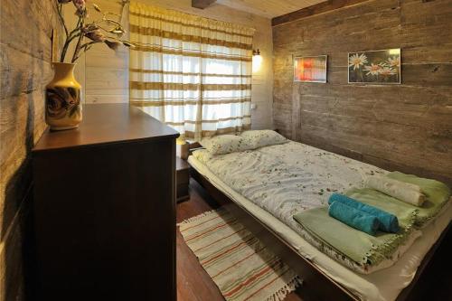 a bedroom with a large bed and a window at Mazury-dom in Świętajno