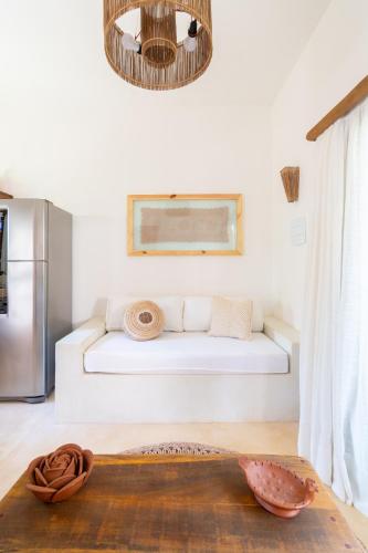 a living room with a white couch in a kitchen at CasaLô Hotel in Jericoacoara