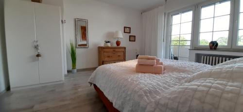a bedroom with a bed with a chair on it at Casa Mediterrana in Erkrath