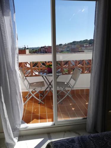 a view of a balcony with two chairs and a table at Nueva suite jacuzzi relax beach & mountain in Palamós