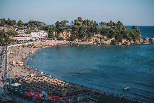 a beach with a large group of people on it at Barba Apartments in Ulcinj
