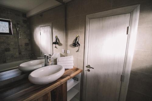 a bathroom with two sinks and a mirror at Barba Apartments in Ulcinj
